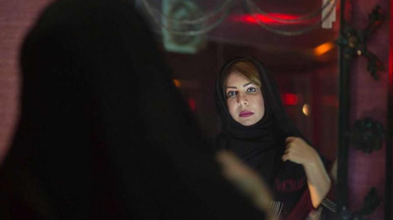 Saudi women's rights activist Souad al-Shammary puts on a head scarf in Jiddah, Saudi Arabia. (Photo: AP) Saudi women's rights activist Souad al-Shammary puts on a head scarf in Jiddah, Saudi Arabia. (Photo: AP)