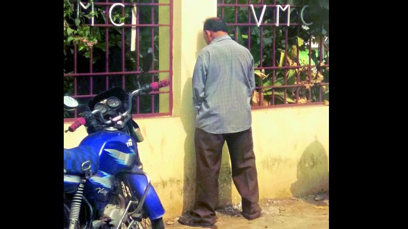 A man urinates on the VMC office wall in Vijayawada though the VMC has installed Mana toilets at many places in the city. (Photo: DECCAN CHRONICLE) A man urinates on the VMC office wall in Vijayawada though the VMC has installed Mana toilets at many places in the city. (Photo: DECCAN CHRONICLE)