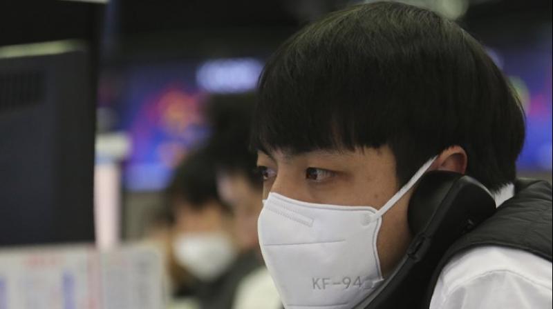 A currency trader talks on the phone at the foreign exchange trading room of the KEB Hana Bank headquarters in Seoul, South Korea. AP photo