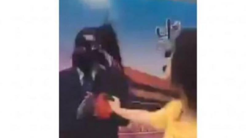 In the video, Dong Yaoqiong splashes ink on a poster bearing President Xi's image at a location in Shanghai's financial district, saying defiantly: 'Xi Jinping, I'm right here waiting for you to arrest me.' (Photo: Screengrab from Twitter/Huayong798) In the video, Dong Yaoqiong splashes ink on a poster bearing President Xi's image at a location in Shanghai's financial district, saying defiantly: 'Xi Jinping, I'm right here waiting for you to arrest me.' (Photo: Screengrab from Twitter/Huayong798)