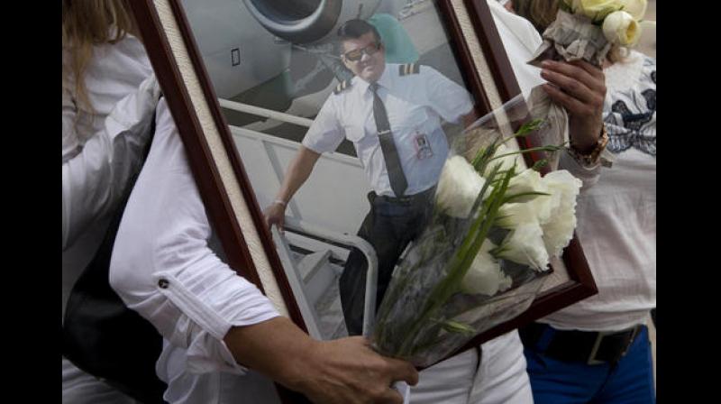 A relative of LaMia pilot Marcelo Quiroga, who died in a plane crash in Colombia, holds his pictures as his remains arrive at the Viru Viru airport in Santa Cruz, Bolivia. (Photo: AP) A relative of LaMia pilot Marcelo Quiroga, who died in a plane crash in Colombia, holds his pictures as his remains arrive at the Viru Viru airport in Santa Cruz, Bolivia. (Photo: AP)