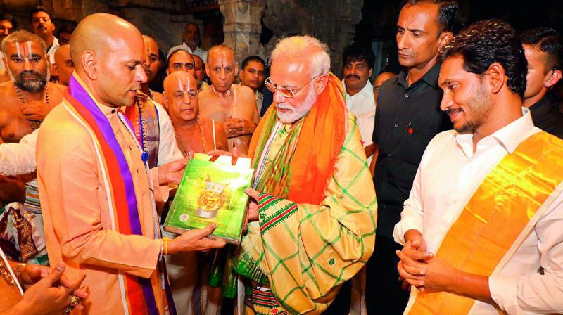 TTD executive officer Anil Kumar Singhal presents a book on antique coins to Prime Minister Narendra Modi at Lord Venkateswara temple during his visit to in Tirupati on Sunday. TTD executive officer Anil Kumar Singhal presents a book on antique coins to Prime Minister Narendra Modi at Lord Venkateswara temple during his visit to in Tirupati on Sunday.