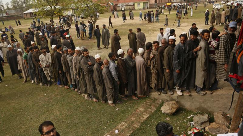 Kashmiri voters stand in a queue to cast their votes outside a polling station at Shadipora. (Photo: AP) Kashmiri voters stand in a queue to cast their votes outside a polling station at Shadipora. (Photo: AP)