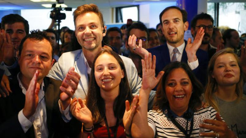 La Republique en Marche party members react after the announcement of the partial official results and polling agencies projections in the final round of parliamentary elections are announced at the party headquarters, in Paris, France. (Photo: AP) La Republique en Marche party members react after the announcement of the partial official results and polling agencies projections in the final round of parliamentary elections are announced at the party headquarters, in Paris, France. (Photo: AP)