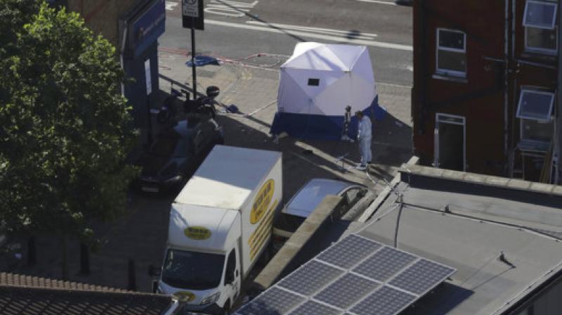 A forensic officer stands at the scene with a van near Finsbury Park station after the vehicle struck pedestrians in north London. (Photo: AP) A forensic officer stands at the scene with a van near Finsbury Park station after the vehicle struck pedestrians in north London. (Photo: AP)
