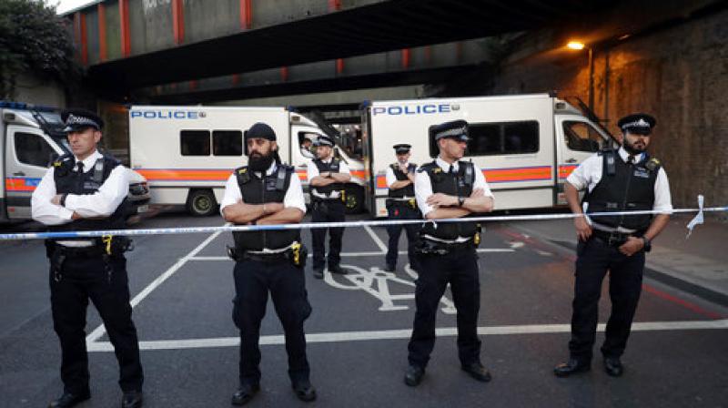 Police stand guard at a cordon on a road near Finsbury Park station after a vehicle struck pedestrians in north London. (Photo: AP) Police stand guard at a cordon on a road near Finsbury Park station after a vehicle struck pedestrians in north London. (Photo: AP)