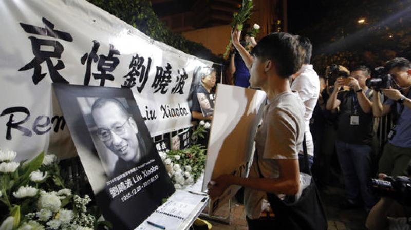 Protesters mourn jailed Chinese Nobel Peace laureate Liu Xiaobo during a demonstration outside the Chinese liaison office in Hong Kong. (Photo: AP) Protesters mourn jailed Chinese Nobel Peace laureate Liu Xiaobo during a demonstration outside the Chinese liaison office in Hong Kong. (Photo: AP)