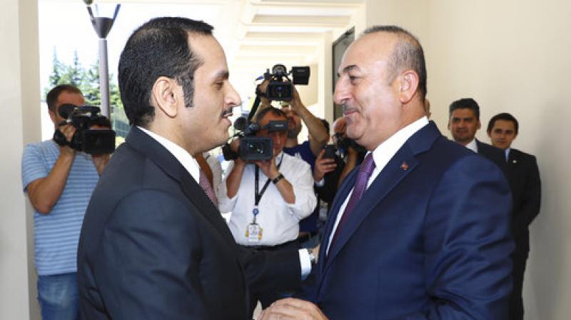 Turkey's Foreign Minister Mevlut Cavusoglu, right, shakes hands with Qatar's Foreign Minister Sheikh Mohammed bin Abdulrahman Al Thani, left, prior to their meeting in Ankara. (Photo: AP) Turkey's Foreign Minister Mevlut Cavusoglu, right, shakes hands with Qatar's Foreign Minister Sheikh Mohammed bin Abdulrahman Al Thani, left, prior to their meeting in Ankara. (Photo: AP)