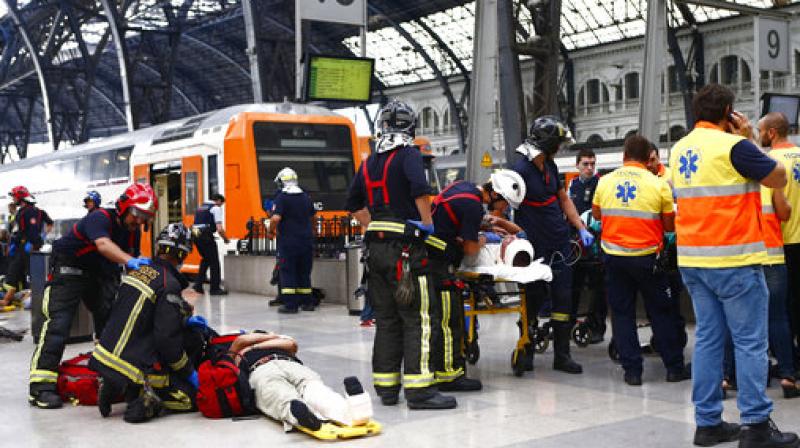 Injured passengers are attended to on the platform of a train station in Barcelona, Spain. Dozens of people were injured when a morning commuter train they were traveling on crashed into the buffers in a station in northeastern Barcelona early Friday. (Photo: AP) Injured passengers are attended to on the platform of a train station in Barcelona, Spain. Dozens of people were injured when a morning commuter train they were traveling on crashed into the buffers in a station in northeastern Barcelona early Friday. (Photo: AP)