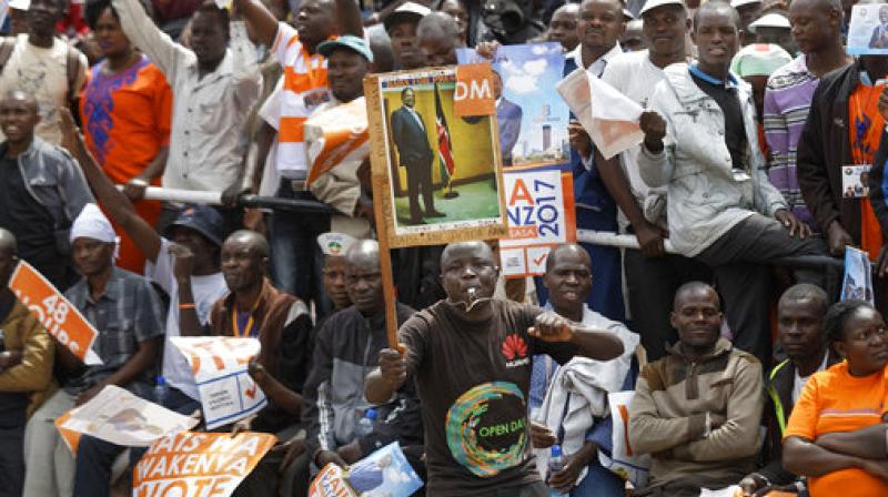 A supporter holds up a placard of opposition leader Raila Odinga at his final electoral campaign rally in Uhuru Park in downtown Nairobi, Kenya. (Photo: AP) A supporter holds up a placard of opposition leader Raila Odinga at his final electoral campaign rally in Uhuru Park in downtown Nairobi, Kenya. (Photo: AP)
