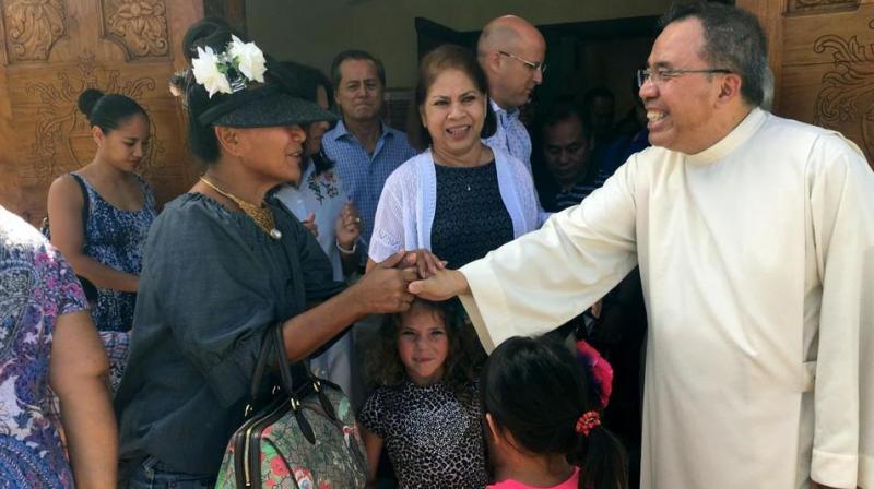 Pastor Fr. Jose Antonio" Lito" P. Abad, right, greets parishioners as they leave Blessed Diego de San Vitores Church following Sunday Mass in Tumon, Guam. (Photo: AP) Pastor Fr. Jose Antonio" Lito" P. Abad, right, greets parishioners as they leave Blessed Diego de San Vitores Church following Sunday Mass in Tumon, Guam. (Photo: AP)