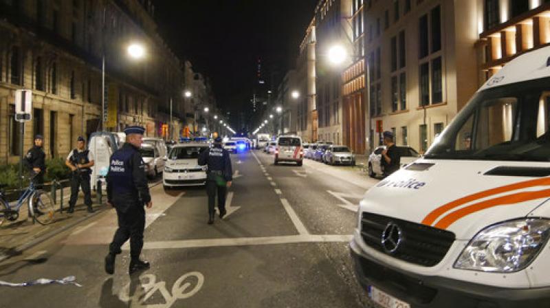 Police secure the scene in downtown Brussels after a reported attack on Belgian Army soldiers on Friday. (Photo: AP) Police secure the scene in downtown Brussels after a reported attack on Belgian Army soldiers on Friday. (Photo: AP)