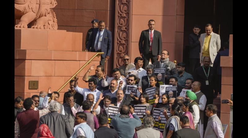 Suspended opposition MPs protest during the Winter session of Parliament, in New Delhi, Tuesday, Dec. 19, 2023. (PTI Photo/Vijay Verma)