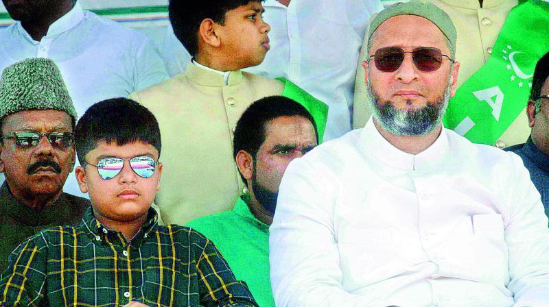 MIM president Asaduddin Owaisi and his son Salahuddin watch the 61st revival day celebrations of the party in Hyderabad on Saturday. MIM president Asaduddin Owaisi and his son Salahuddin watch the 61st revival day celebrations of the party in Hyderabad on Saturday.