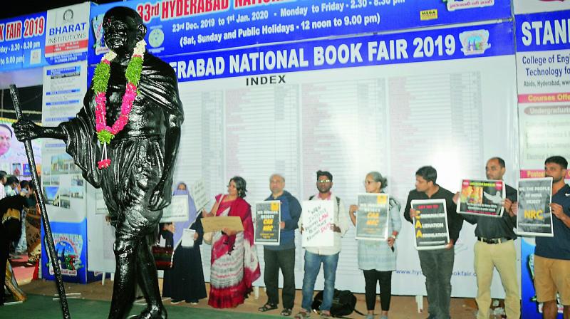 A group of people protests against the CAA and the NRC at the Hyderabad Book Fair on Saturday. (Photo: Deepak Deshpande)