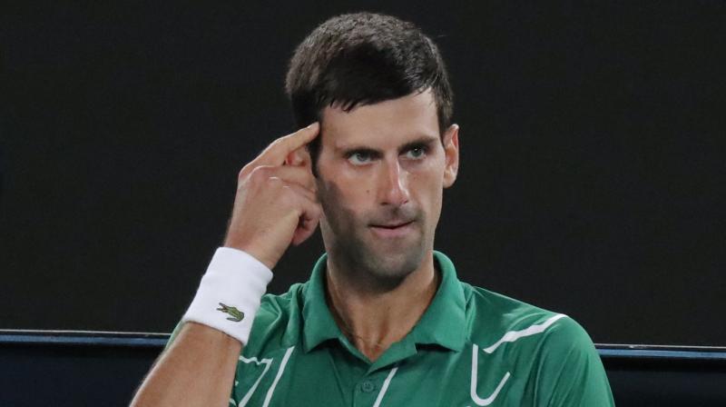 CEREBRAL STUFF: Serbias Novak Djokovic gestures to himself during a break in his mens singles final against Austrias Dominic Thiem at the Australian Open. AP Photo