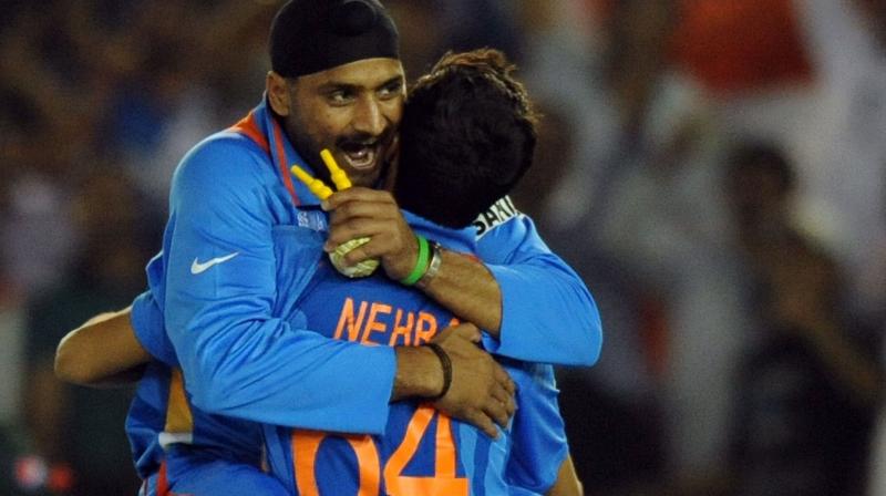 COMRADES IN ARMS: Harbhajan Singh and Ashish Nehra. AFP Photo