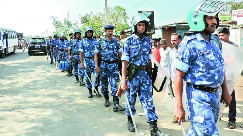 Rapid Action Force personnel patrol at Hasnapur in Utnoor mandal on Saturday after Friday’s clashes between Adivasi and Lambada groups. (Photo: DC) Rapid Action Force personnel patrol at Hasnapur in Utnoor mandal on Saturday after Friday’s clashes between Adivasi and Lambada groups. (Photo: DC)