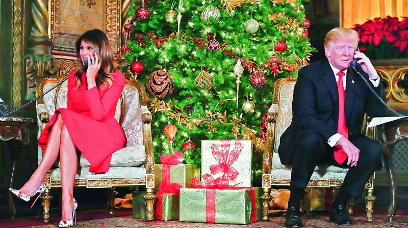 President Donald Trump and First Lady Melania Trump speak on the phone with children as they track Santa Claus movements with the North American Aerospace Defense Command Santa Tracker on Christmas Eve at the President’s Mar-a-Lago estate in Palm Beach, on Monday. (Photo: PTI) President Donald Trump and First Lady Melania Trump speak on the phone with children as they track Santa Claus movements with the North American Aerospace Defense Command Santa Tracker on Christmas Eve at the President’s Mar-a-Lago estate in Palm Beach, on Monday. (Photo: PTI)