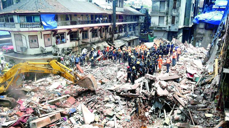 Fire brigade and NDRF personnel carry out search and rescue operations following the collapse of a building at Pakmodiya Street in South Mumbai on Thursday. (Photo: PTI) Fire brigade and NDRF personnel carry out search and rescue operations following the collapse of a building at Pakmodiya Street in South Mumbai on Thursday. (Photo: PTI)