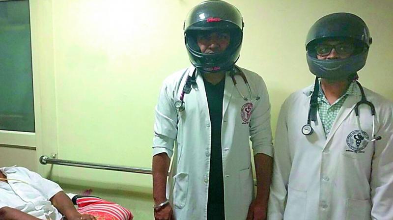 AIIMS doctors wear helmets as a sign of protest against assaults. (Photo: Agencies) AIIMS doctors wear helmets as a sign of protest against assaults. (Photo: Agencies)