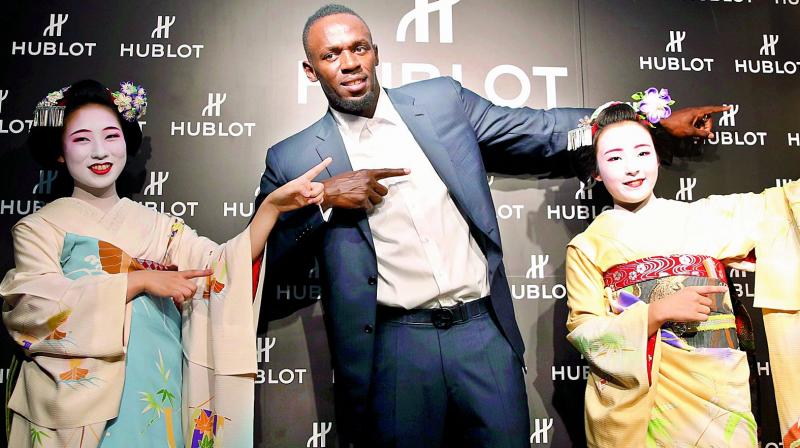 Usain Bolt of Jamaica gestures with maiko, or an apprentice geisha, during a promotional event in Kyoto, western Japan on Tuesday. (Photo: AP) Usain Bolt of Jamaica gestures with maiko, or an apprentice geisha, during a promotional event in Kyoto, western Japan on Tuesday. (Photo: AP)