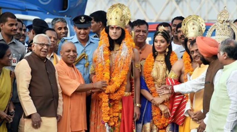 Uttar Pradesh Chief Minister Yogi Adityanath performs 'Abhishek' of artistes dressed up as Lord Rama, Sita and Lakshman during Deepotsav celebrations in Ayodhya on Wednesday. (Photo: PTI) Uttar Pradesh Chief Minister Yogi Adityanath performs 'Abhishek' of artistes dressed up as Lord Rama, Sita and Lakshman during Deepotsav celebrations in Ayodhya on Wednesday. (Photo: PTI)
