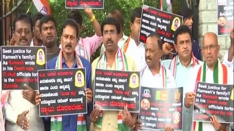 While one placard sought justice for the deceased and the other accused government of targeting the leaders to take the political revenge. (Photo: ANI) While one placard sought justice for the deceased and the other accused government of targeting the leaders to take the political revenge. (Photo: ANI)