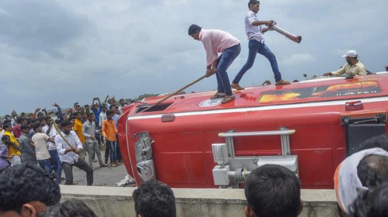 Pro-reservation outfits of Maratha community burn a vehicle after a clash with the police personnel. (Photo: PTI) Pro-reservation outfits of Maratha community burn a vehicle after a clash with the police personnel. (Photo: PTI)