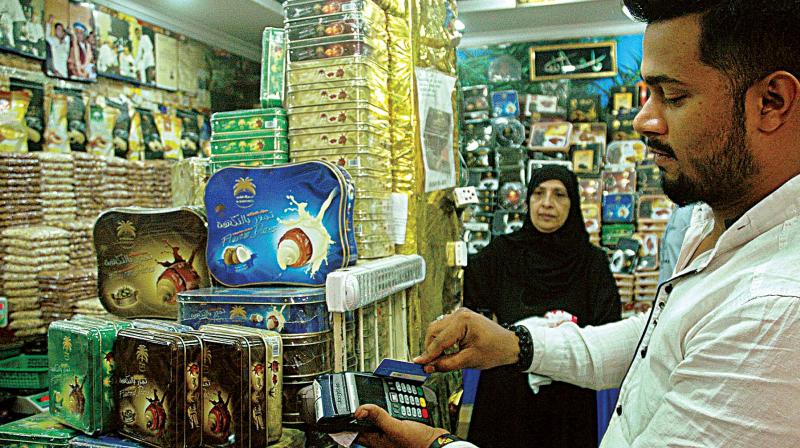 A vendor at Russel Market swipes the card of a customer in Bengaluru on Wednesday (Photo: DC) A vendor at Russel Market swipes the card of a customer in Bengaluru on Wednesday (Photo: DC)