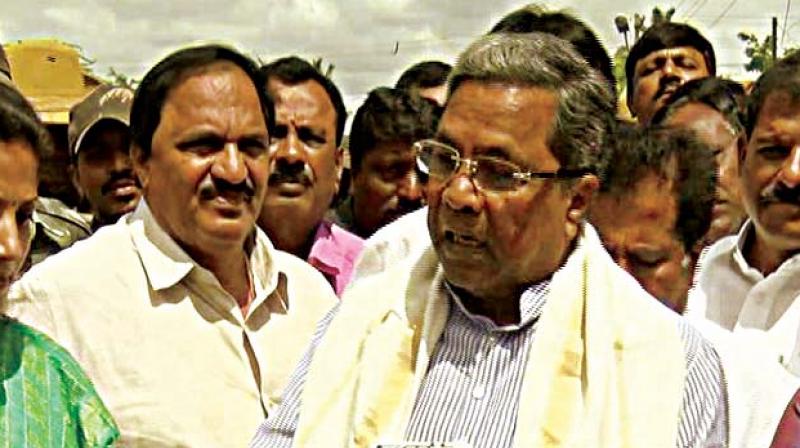 A file photo of Chief Minister Siddaramaiah with his aide Mari Gowda (left) A file photo of Chief Minister Siddaramaiah with his aide Mari Gowda (left)