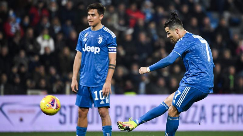 Juventus' Portuguese forward Cristiano Ronaldo shoots a free kick next to Juventus' Argentine forward Paulo Dybala during the Italian Serie A football match against SPAL on February 22, 2020 at the Paolo-Mazza stadium in Ferrara. (AFP) Juventus' Portuguese forward Cristiano Ronaldo shoots a free kick next to Juventus' Argentine forward Paulo Dybala during the Italian Serie A football match against SPAL on February 22, 2020 at the Paolo-Mazza stadium in Ferrara. (AFP)