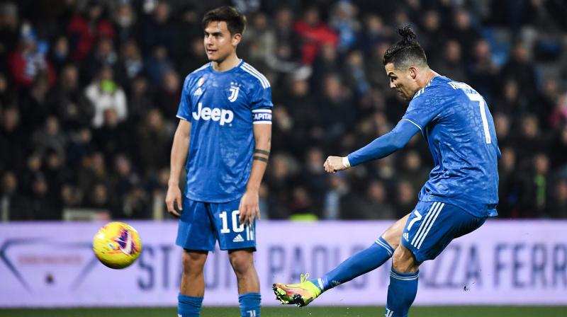 Juventus Portuguese forward Cristiano Ronaldo shoots a free kick next to Juventus Argentine forward Paulo Dybala during the Italian Serie A football match against SPAL on February 22, 2020 at the Paolo-Mazza stadium in Ferrara. (AFP)