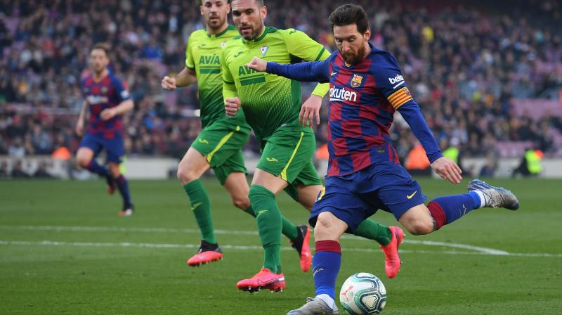 Barcelonas Argentine forward Lionel Messi (right) kicks the ball during Barcelonas Spanish league football match against SD Eibar at the Camp Nou stadium in Barcelona on February 22, 2020. (AFP)