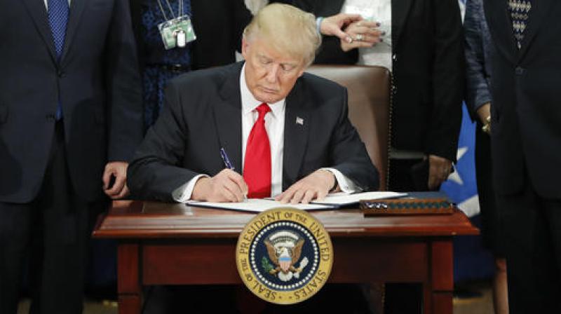 President Donald Trump signs an executive order. (Photo: AP) President Donald Trump signs an executive order. (Photo: AP)