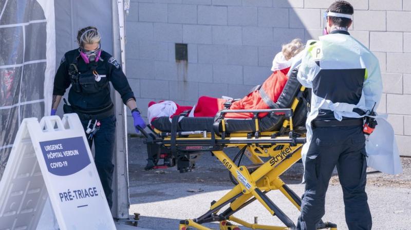 A patient is wheeled into the emergency unit of the Verdun Hospital in Montreal on Monday, April 6, 2020. Prime Minister Justin Trudeau says hes confident Canada will still be able to import N95 protective masks form the U.S. despite an export ban and says he will talk to U.S. President Donald Trump in the coming days. (AP Photo)