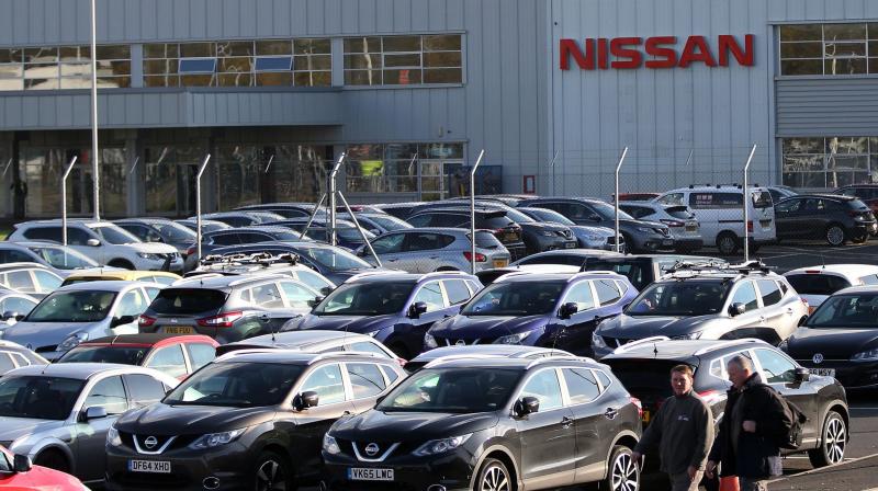 Workers leave the Nissan car plant after finishing their shift. (Photo- AFP) Workers leave the Nissan car plant after finishing their shift. (Photo- AFP)