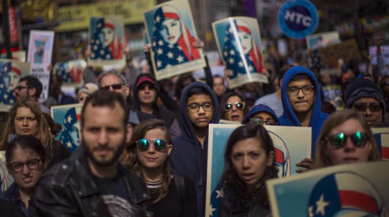 People carry posters during a rally in support of Muslim Americans and protest of President Donald Trump's immigration policies in Times Square, New York. (Photo: AP) People carry posters during a rally in support of Muslim Americans and protest of President Donald Trump's immigration policies in Times Square, New York. (Photo: AP)
