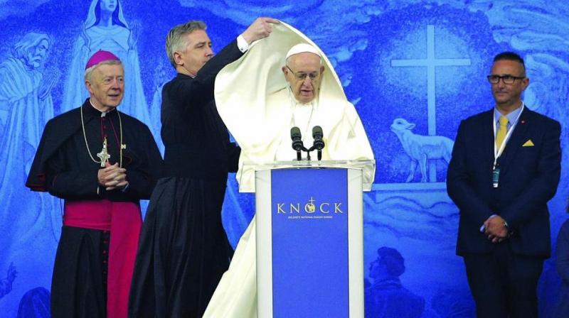 An aide adjusts Pope Francis’ cape as he speaks at the Knock Shrine in Knock, Ireland, on Sunday. Pope Francis was on a two-day visit to Ireland. (Photo: AP) An aide adjusts Pope Francis’ cape as he speaks at the Knock Shrine in Knock, Ireland, on Sunday. Pope Francis was on a two-day visit to Ireland. (Photo: AP)