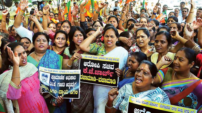 BJP Mahila Morcha members led by Udupi-Chikkamagaluru MP Shobha Karandlaje stage a protest in Bengaluru on Monday demanding the resignation of Bengaluru development minister K.J. George for his alleged involvement in the DySP Ganapathi suicide. BJP Mahila Morcha members led by Udupi-Chikkamagaluru MP Shobha Karandlaje stage a protest in Bengaluru on Monday demanding the resignation of Bengaluru development minister K.J. George for his alleged involvement in the DySP Ganapathi suicide.