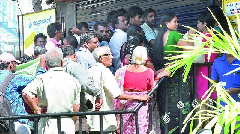People waiting in front of an ATM that was partially closed at the Andhra Bank main branch at Seethammadhara in Visakhapatnam on Wednesday. (Photo: DC) People waiting in front of an ATM that was partially closed at the Andhra Bank main branch at Seethammadhara in Visakhapatnam on Wednesday. (Photo: DC)