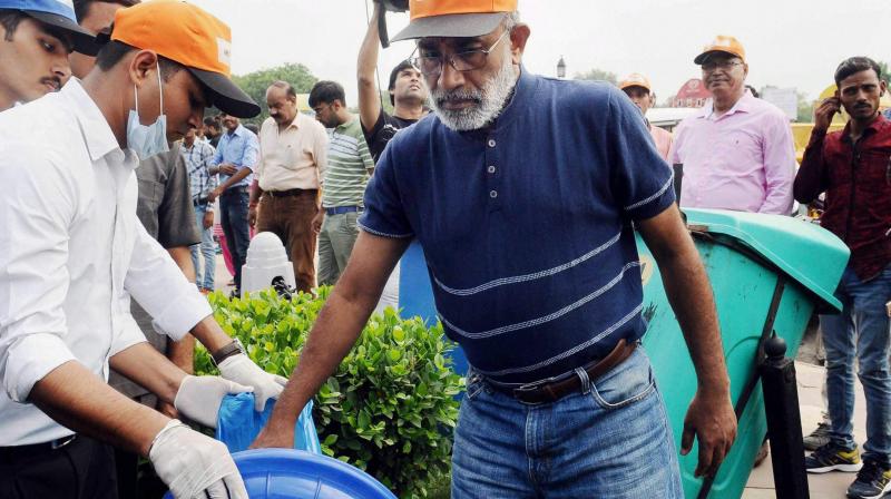 Minister of State for Tourism (I/C) and Electronics & Information Technology, Alphons Kannanthanam participating in a cleanliness drive as part of ‘Swachhta Hi Sewa’ campaign, organised by Ministry of Tourism, in New Delhi on Sunday. (Photo: PTI) Minister of State for Tourism (I/C) and Electronics & Information Technology, Alphons Kannanthanam participating in a cleanliness drive as part of ‘Swachhta Hi Sewa’ campaign, organised by Ministry of Tourism, in New Delhi on Sunday. (Photo: PTI)