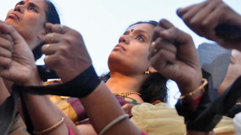 Women lock their hands with a cloth at the Gandhi Square in Kochi on Saturday in protest against the brutal way in which tribal youth Madhu was killed in Attappadi the other day. (Photo: SUNOJ NINAN MATHEW.) Women lock their hands with a cloth at the Gandhi Square in Kochi on Saturday in protest against the brutal way in which tribal youth Madhu was killed in Attappadi the other day. (Photo: SUNOJ NINAN MATHEW.)