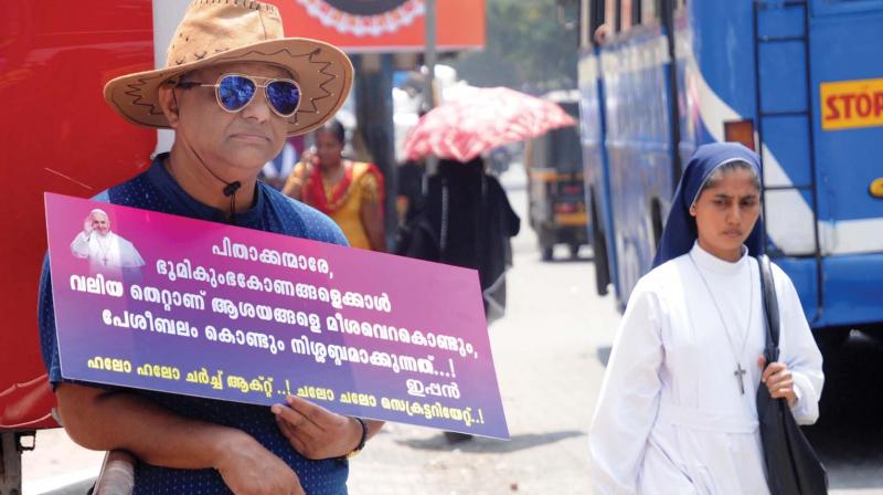 Professor Joseph Varghese holds a placard demanding the introduction of Church Act in the wake of the land deal controversy involving Ernakulam-Angamaly Archdiocese of Syro Malabar Church in Kochi. — FILE Professor Joseph Varghese holds a placard demanding the introduction of Church Act in the wake of the land deal controversy involving Ernakulam-Angamaly Archdiocese of Syro Malabar Church in Kochi. — FILE