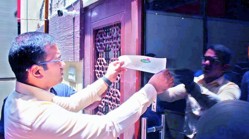 Khairatabad Zonal commissioner Musharraf Faruqui seizing a pub in Jubilee Hills on Friday. Khairatabad Zonal commissioner Musharraf Faruqui seizing a pub in Jubilee Hills on Friday.