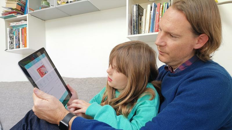 In this photo, Paddy Kelly and his daughter Ailish use Gohenry, one of a wave of digital banking apps for children, in London. (AP Photo/Kelvin Chan) In this photo, Paddy Kelly and his daughter Ailish use Gohenry, one of a wave of digital banking apps for children, in London. (AP Photo/Kelvin Chan)