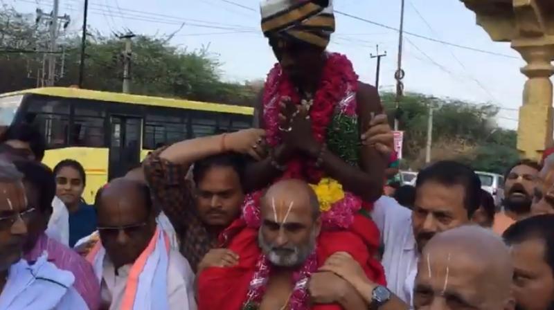 CS Rangarajan of Chilkur Balaji Temple carried Aditya Parasri into the sanctum sanctorum (Photo: Facebook) CS Rangarajan of Chilkur Balaji Temple carried Aditya Parasri into the sanctum sanctorum (Photo: Facebook)