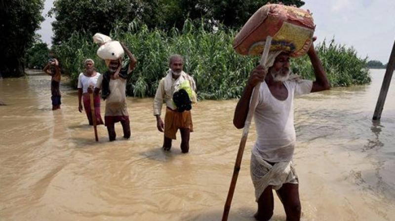 Flood-hit people shift with their belongings at Runni Saidpur in Sitamarhi district on Thursday. (Photo: PTI) Flood-hit people shift with their belongings at Runni Saidpur in Sitamarhi district on Thursday. (Photo: PTI)