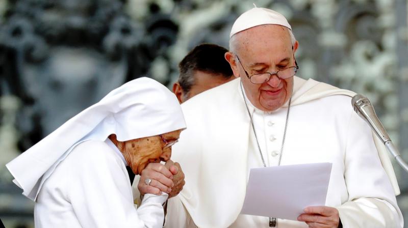 While visiting a Catholic shrine in Loreto on Monday, Pope Franics repeatedly kept withdrawing his right hand as a long line of people bowed down and tried to kiss the ring on it. (Photo: AFP) While visiting a Catholic shrine in Loreto on Monday, Pope Franics repeatedly kept withdrawing his right hand as a long line of people bowed down and tried to kiss the ring on it. (Photo: AFP)