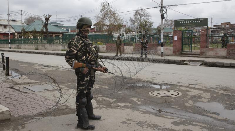 Indian paramilitary soldiers stand guard near a temporary checkpoint during lockdown in Srinagar. AP Photo